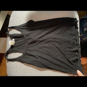 Tillys black tank top with a ruffled hem